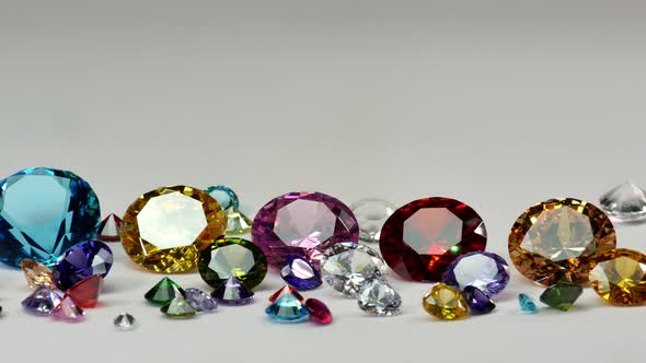 Colorful Diamonds Of Various Sizes Glittering On A White Background alt