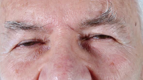 Man Winking His Eyes In Close Up alt