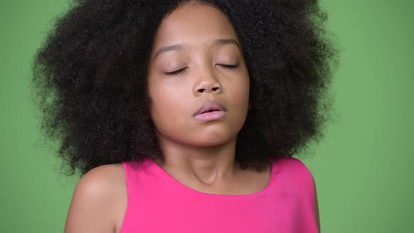 Young Cute African Girl with Afro Hair Relaxing with Eyes Closed alt