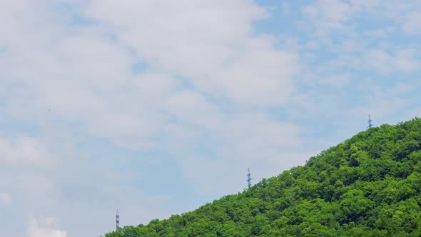 Sky Cloud Timelapse in Background of High Voltage Tower on Green Mountain alt