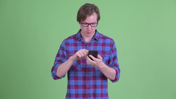 Happy Young Handsome Hipster Man Using Phone and Getting Good News alt