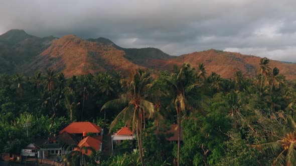 Aerial footage over tropical village in Jungle and Mountains