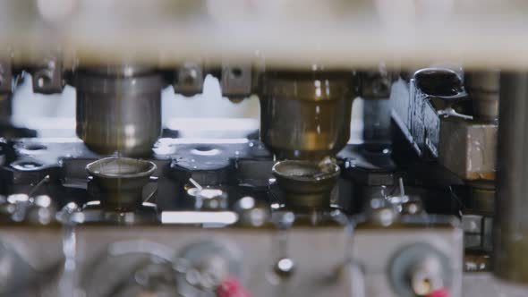 Close up of a punch press forming metal parts in a production line alt