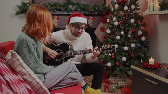 Young happy active family couple singing laughing together Christmas holiday. alt