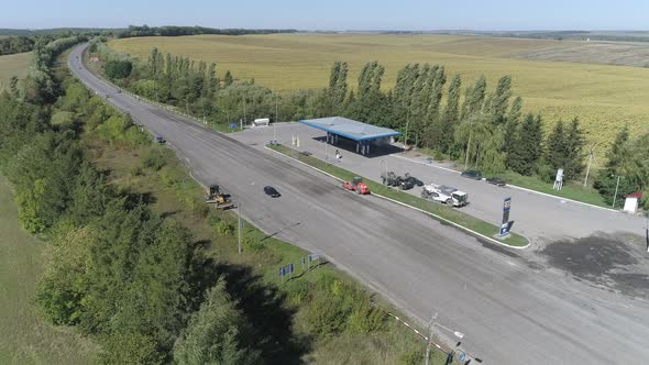 Aerial of a gas station next to a road alt