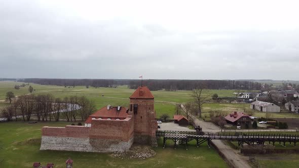 Aerial View of Liw Castle in Poland with a Flag