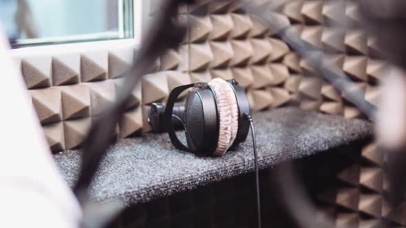 Man's Hands Take Away Headphones in Recording Studio