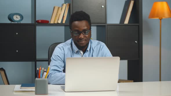 African American Businessman Using Laptop at Modern Office alt