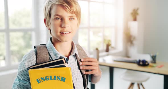 Smiling Boy Holding English Book