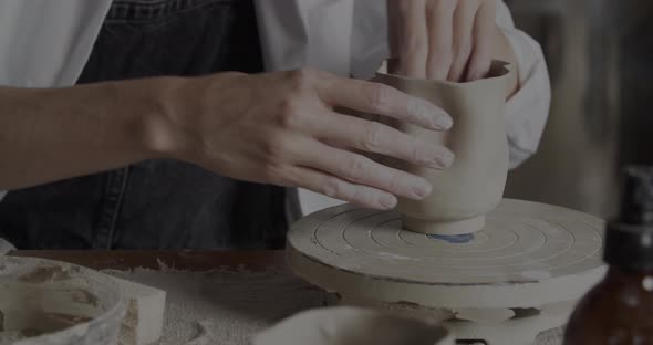 Potter Shaping A Clay Cup By Hand