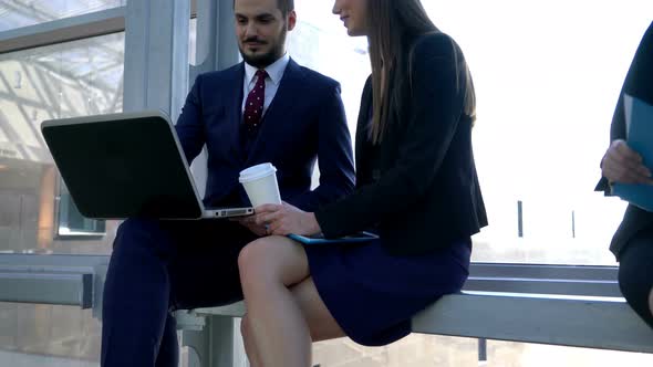 Two Coworkers Discussing Work Project on Break