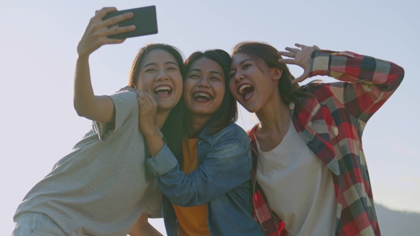 Group of a young Asian woman taking selfies having fun together a summer traveling.