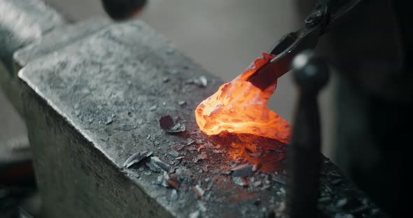 Blacksmith Forges the Red Hot Decorative Metal Product with Hammer on the Anvil Decorative Forging alt