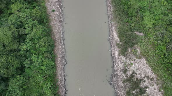 Aerial shot of a flowing river in a rainforest