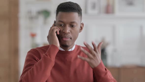 Portrait of African Businessman Talking Angrily on Smartphone alt