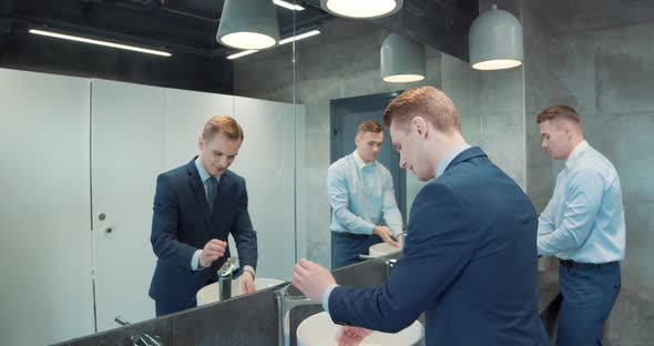 Two Business Man in Office Bathroom alt