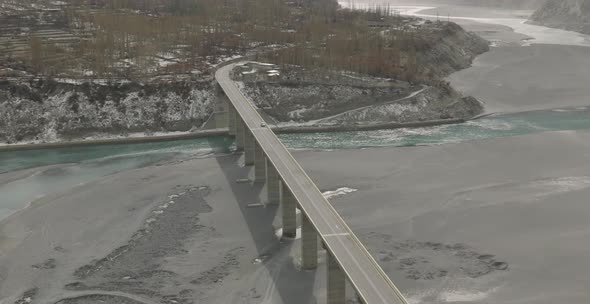 Aerial view of bridge across blue lake in summer landscape Tranquil Lake Surrounded By Rocky Slopes alt