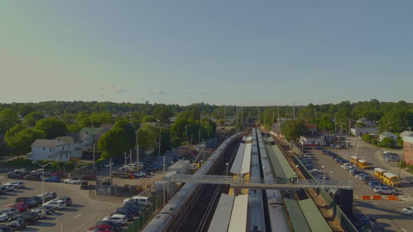 Forward Aerial Pan of Train Leaving the Station in Port Washington Long Island alt