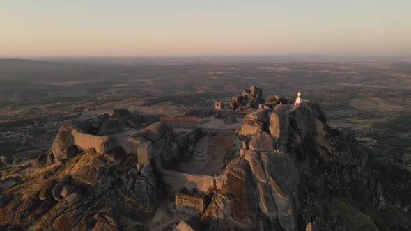 Drone flying over Monsanto castle ruins and surrounding landscape, Portugal alt