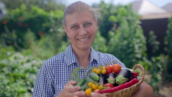 Portrait Of Woman Holding Basket With Fresh Vegetables alt