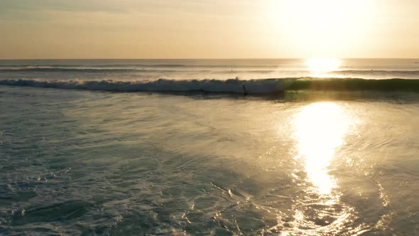 Following large waves at sunset