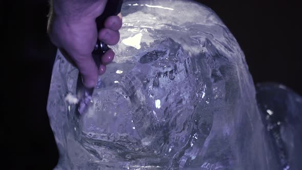 Professional Artist is Carving an Ice Sculpture of a Lion Using a Knife alt