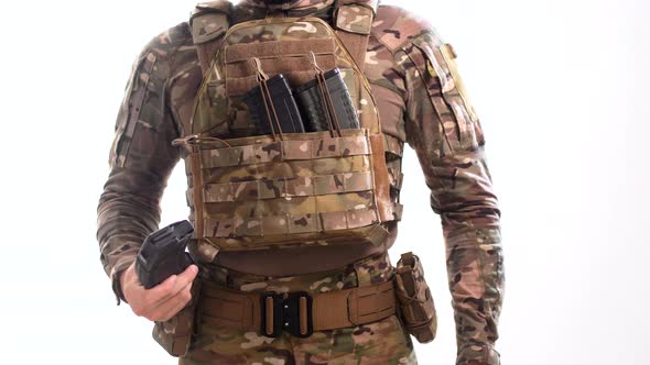 Special operations officer in multicam camouflage removes a loaded magazine