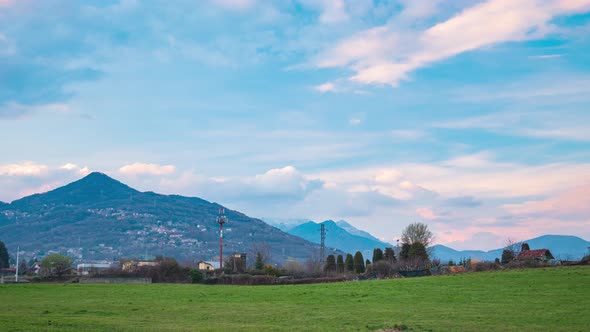 Time lapse: sunset over the Alps, unique scenery panoramic view alpine valley moving clouds, spring  alt