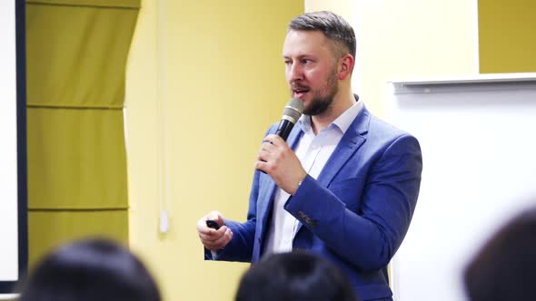 Assertive male politician speaking into microphones on political convention. alt