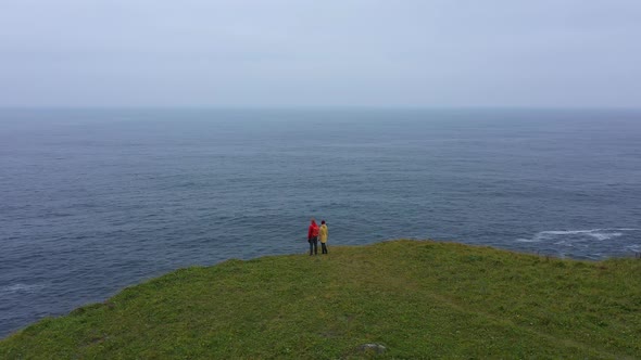 Couple of Travelers on the Cape End of the World on Shikotan Island, Lesser Kuril Chain, Russia.