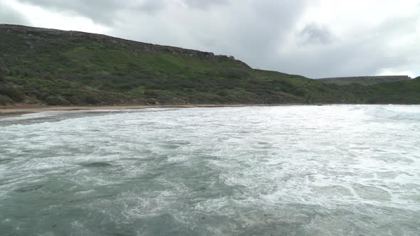 Panoramic Shot of Ghajn Tuffieha Bay on a Cloudy Winter Day with Strong Wind Blowing Over Sea