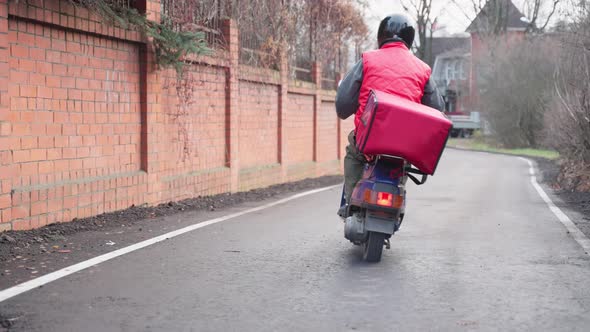Courier Delivering Parcel Box By Motorcycle or Scooter