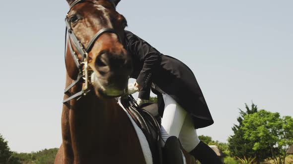 Caucasian woman riding her dressage horse alt