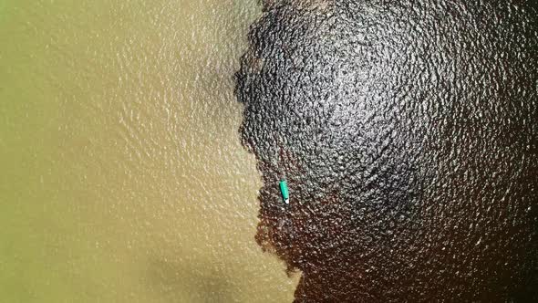 Boat with Tourists on the Border of Two Rivers of Different Density in Rio Negro Brazil alt