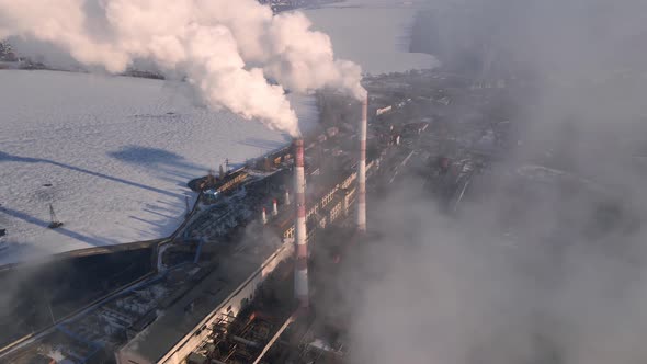 Factory pipes emissions of carbon gases with smoke in atmosphere alt