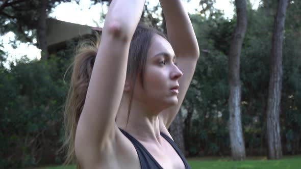 The girl goes in for sports, yoga, stretches, does gymnastics, morning exercises. A girl is watching alt