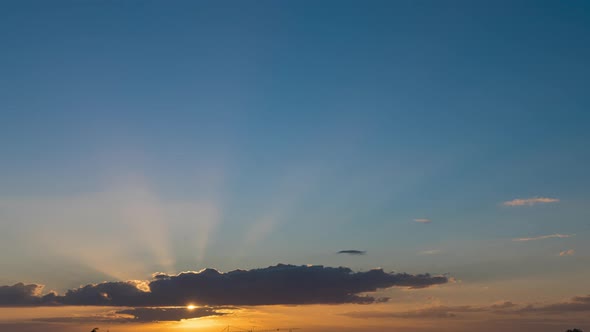 Sun Light Rays Timelapse Behind a Big Cloud during Sunset July France alt