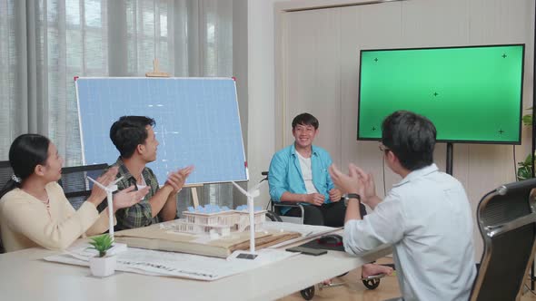 Asian Man Engineer In Wheelchair With Solar Cell Succeed Presenting About The Green Screen TV alt