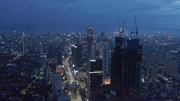 Aerial Truck Shot of Night Time Cityscape of Jakarta City Center with Traffic on the Multi Lane alt