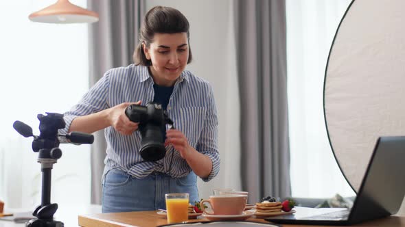 Female Food Photographer with Laptop in Kitchen