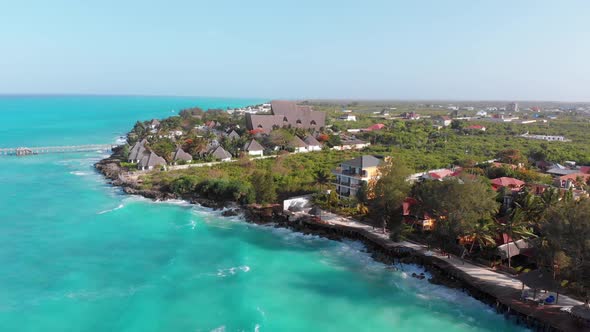 Aerial Tropical Landscape of Zanzibar Waves Hit Reef on Hotels Coastline Palms alt
