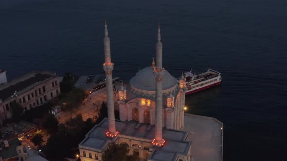 Illuminated Ortakoy Mosque From Above at Dusk, Aerial Birds Eye View Perspective alt