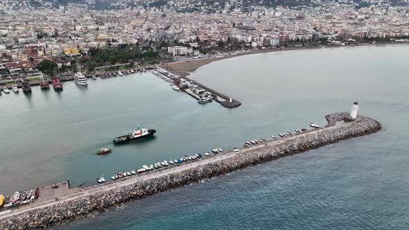 Ship tug sails out of port aerial view Turkey Alanya 4 K alt