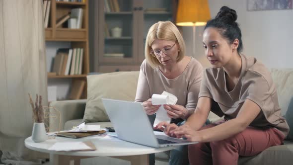 Women Paying Bills Via Laptop alt
