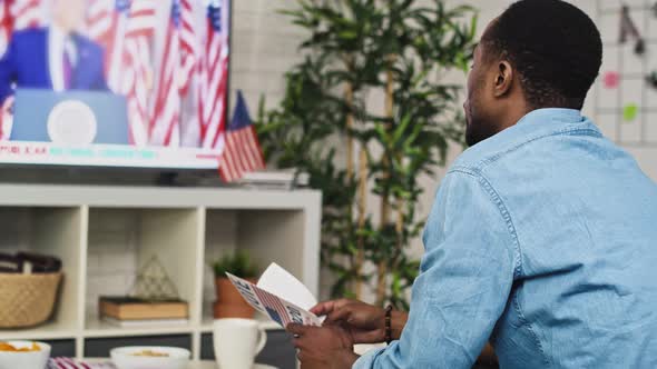 Video of man interested in watching TV of USA election. Shot with RED helium camera in 8K. alt