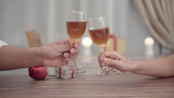 Close up romantic couple clink champagne or wine toast in a dinner at restaurant