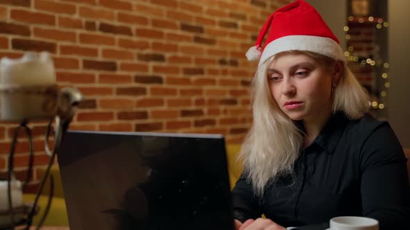 Female person working laptop at home office indoors in evening closeup. Woman 30s looking notebook alt