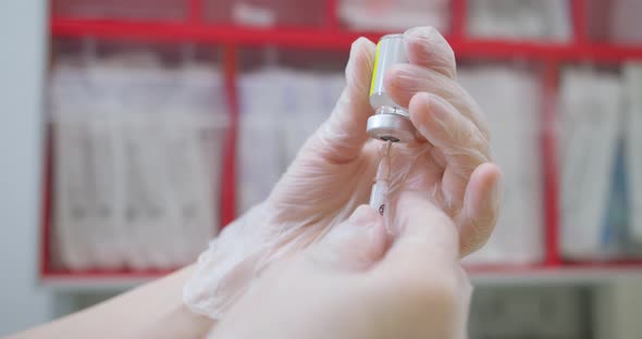 Close Up of Nurse Hands Holding a Coronavirus Measles or Flu Vaccine Applying Vaccine Into the