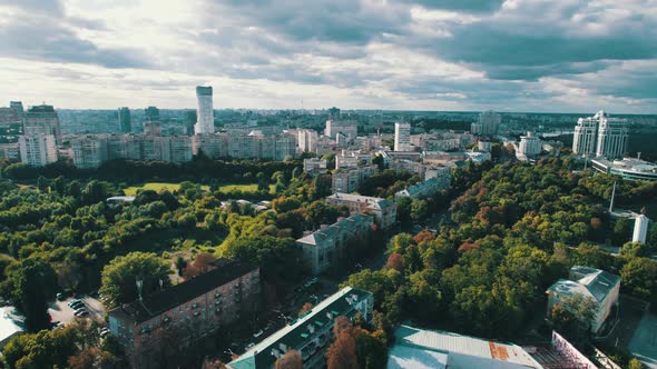 Aerial View of Metropolis City Skyline with Skyscrapers Green Trees and Sky alt