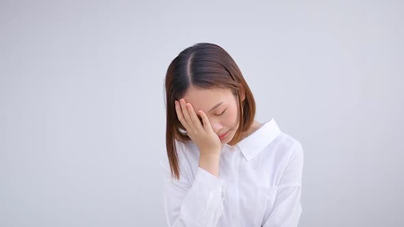 Asian girl is tired, frustrated, standing, sighing from exhaustion after working for a long time.